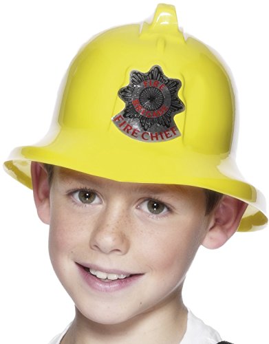 A young boy wearing a yellow firefighter's helmet with a "Firefighter Chief" badge.