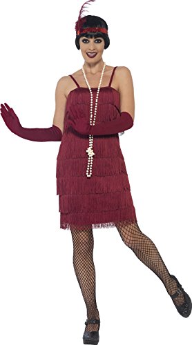 Woman in red 1920s flapper costume, fishnet tights, and pearl necklace, posing against a white background.