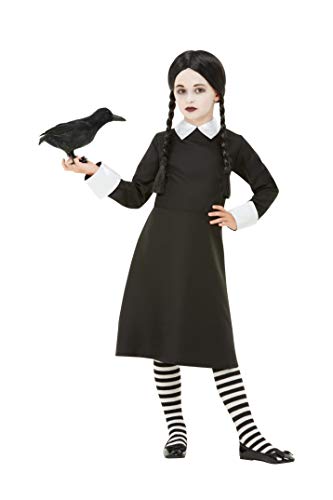 Young girl in a black schoolgirl costume with a raven prop.