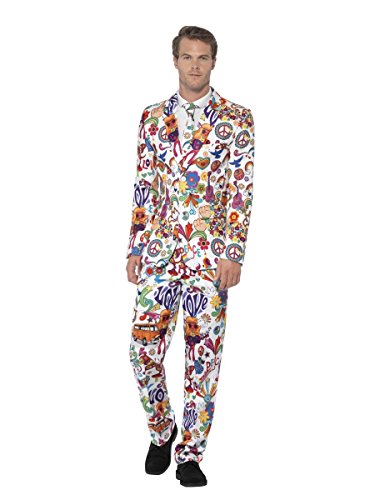 Man wearing a white suit covered in colorful peace signs and flowers.