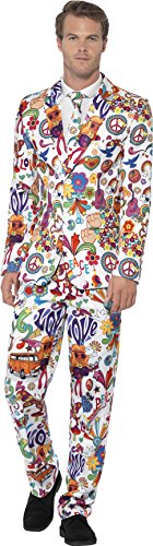 Man wearing a white suit with multicolored psychedelic patterns, standing against a white background.