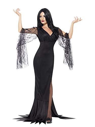 Woman in a long black gown with lace sleeves, posing with arms raised.