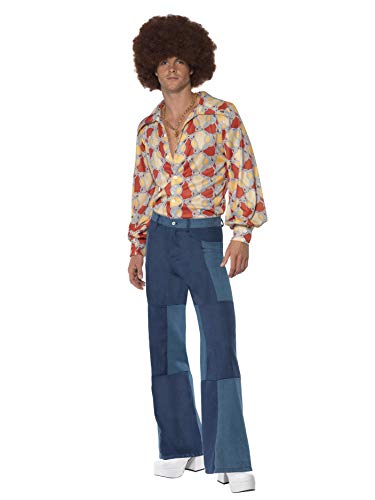 Man modeling blue patchwork flared trousers and a patterned shirt.