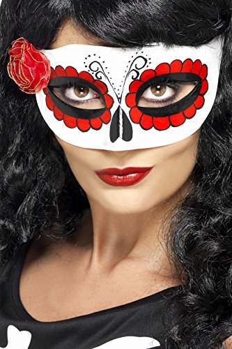 A woman wears a white mask with red and black sugar skull design and rose.