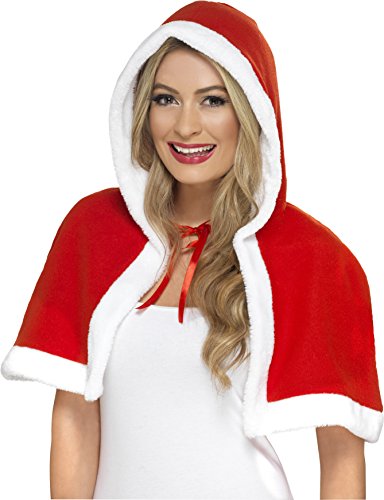 Woman wearing a red and white hooded cape over a white dress, smiling.