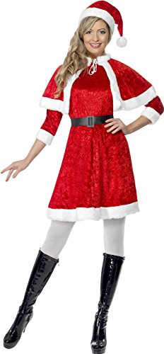 Woman wearing red and white Miss Santa costume, hat, and black boots, posing confidently.