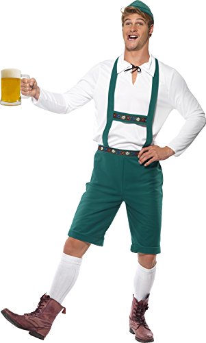 Man wearing green lederhosen costume, white shirt, and hat, holding a beer mug.