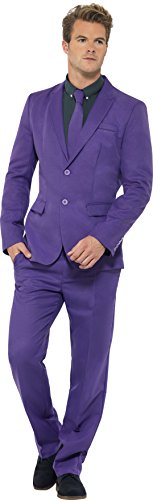 Man wearing a purple suit with a dark shirt and tie, standing against a white background.