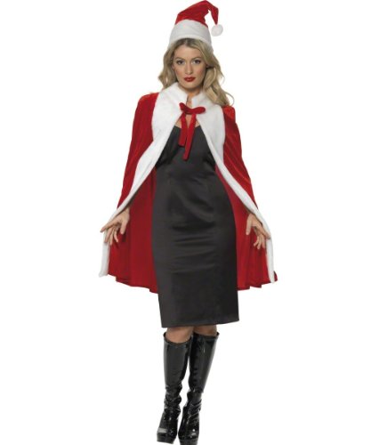 Woman wearing a red and white cape, black dress, and Santa hat, standing against a white background.