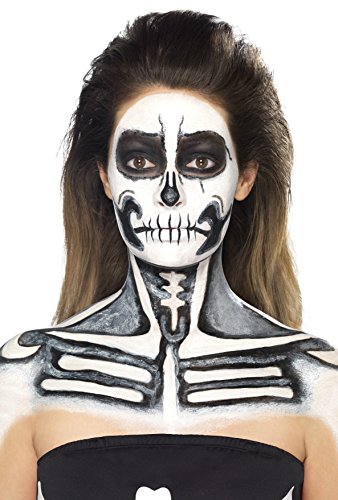 A woman with a skeleton face paint design on her face and upper body.