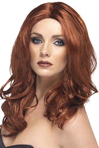 Woman modeling a long, wavy auburn wig with a center part.