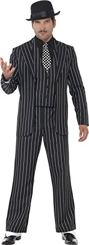Man dressed in black pinstripe suit, black fedora, and checkered tie, standing against a white background.
