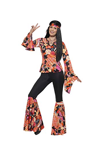 Woman in a brightly patterned, flared hippie costume making a peace sign.