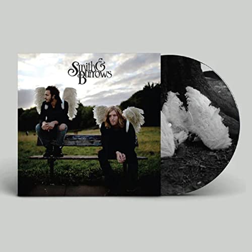 Album cover featuring two men with angel wings sitting on a park bench.