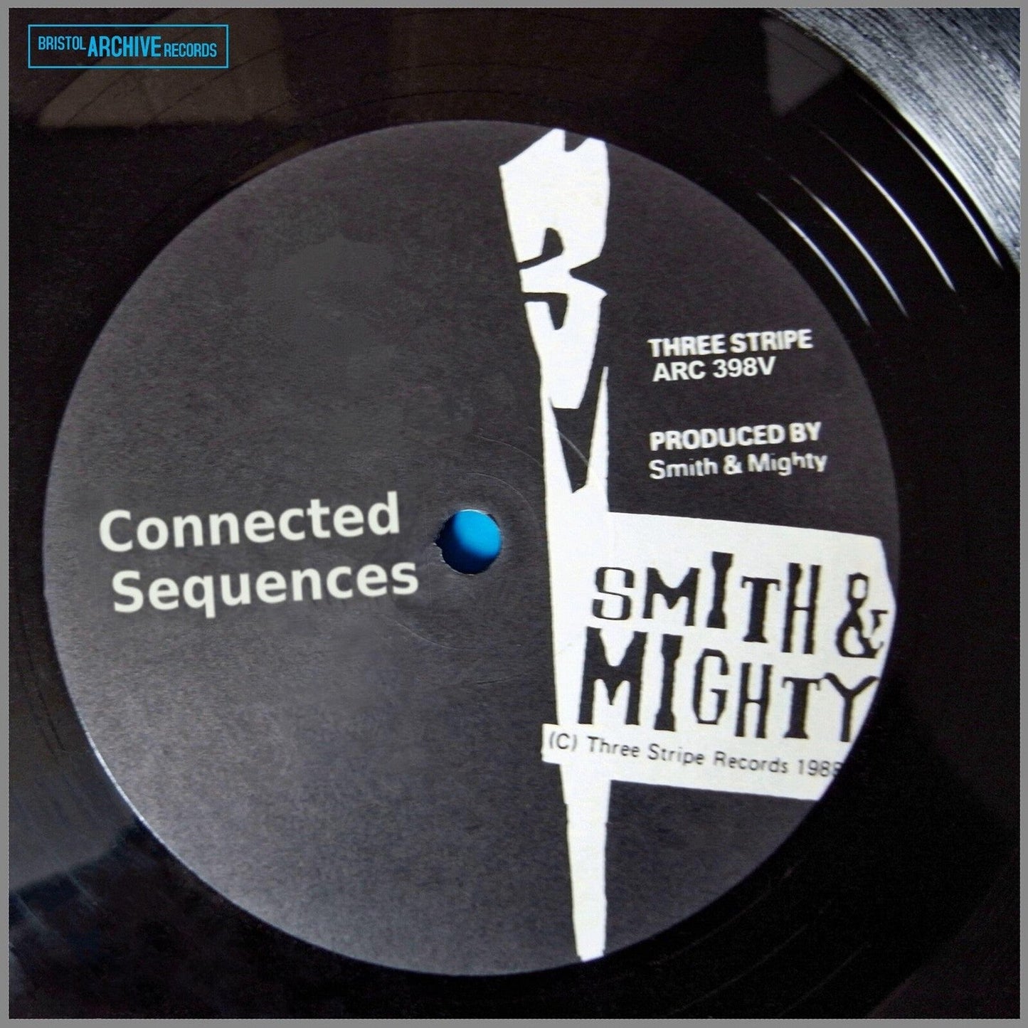 Black vinyl record label with white text and abstract graphic.