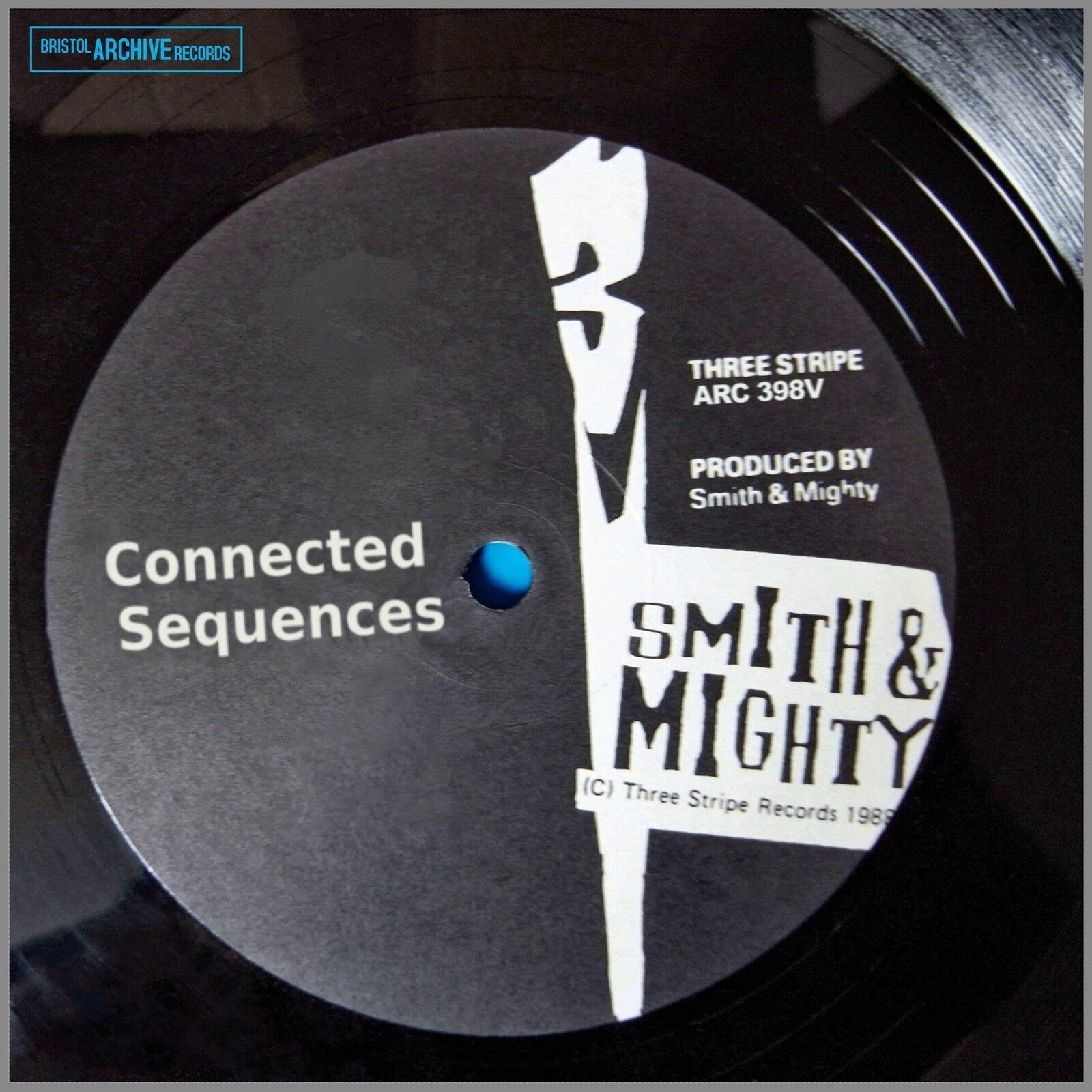 Black vinyl record label with white text and abstract graphic.