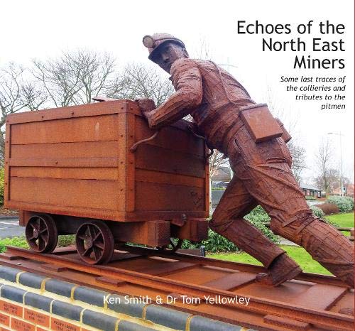 Rusty metal sculpture of a miner pushing a coal cart on rails.