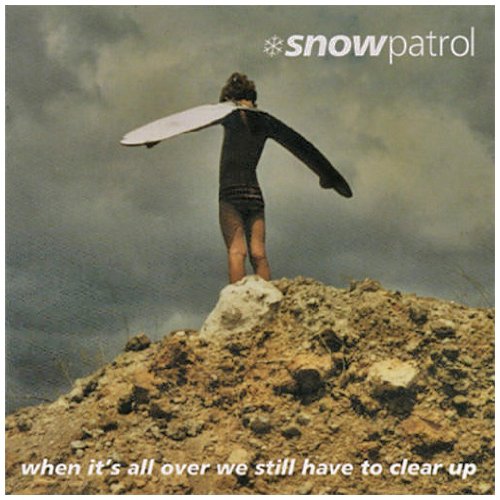 Snow Patrol album cover: person with surfboard on a hill.