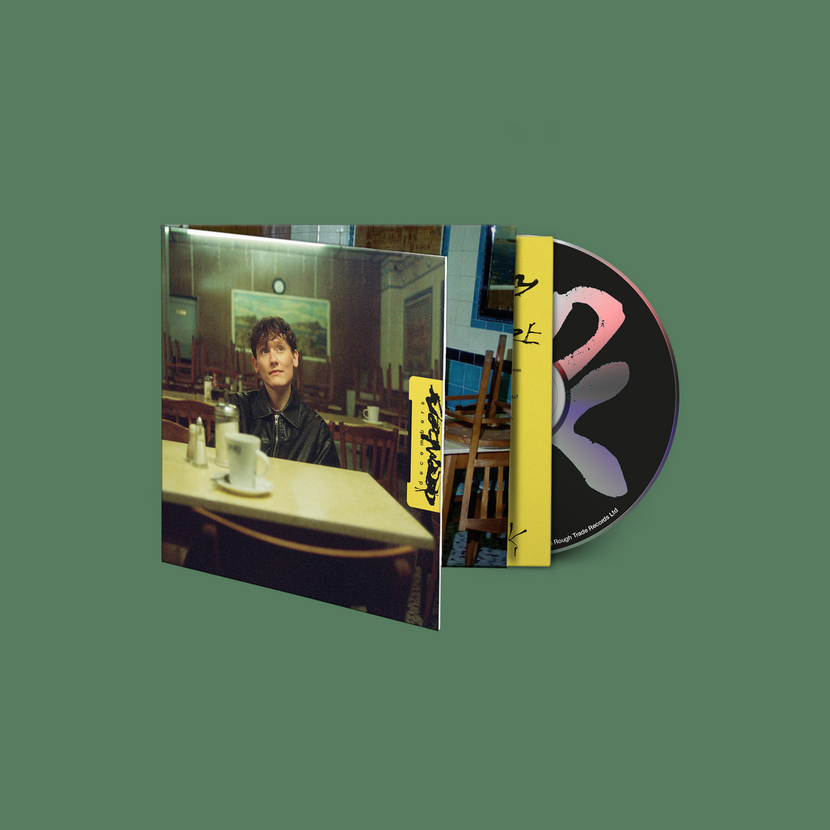 SOAK "decembers" CD packaging with a man seated in a diner.