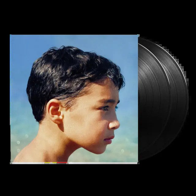Vinyl record album cover featuring a profile portrait of a young boy against water.