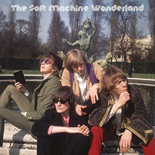 Album cover featuring four men posing in front of a statue and trees.