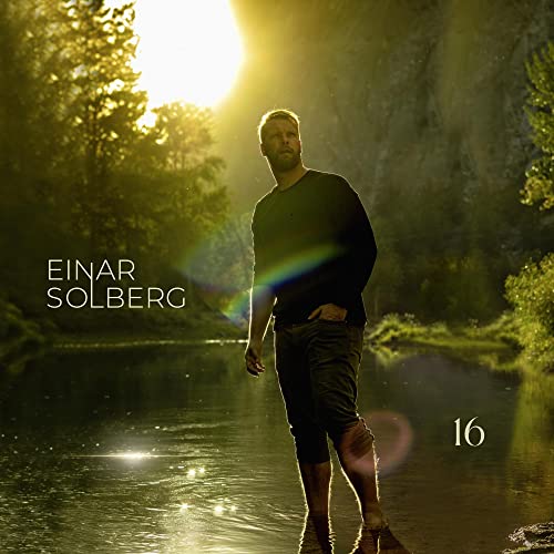 Einar Solberg album cover: man standing in water, sunlit forest background.