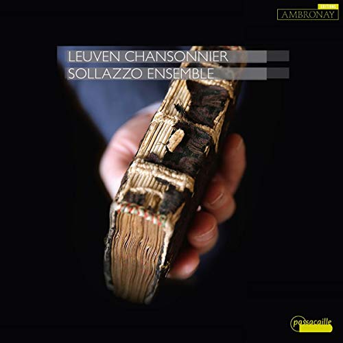 "CD cover featuring a hand holding an ornate, gold-colored book against a dark background."