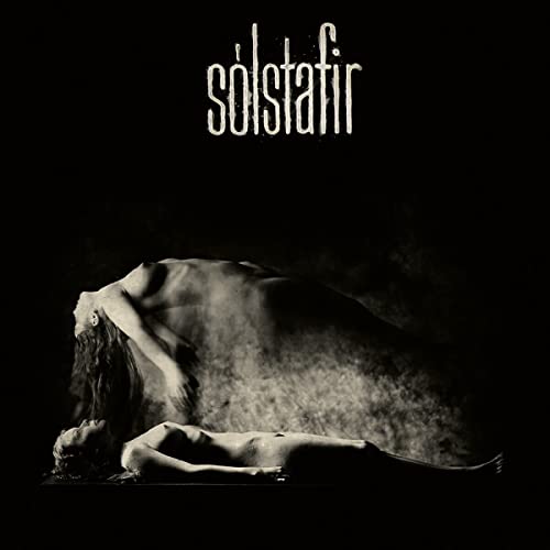Black and white album cover with figures lying on dark ground.