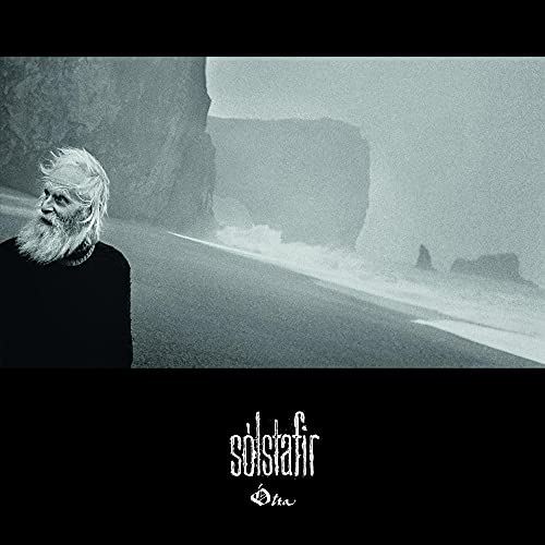 Black and white album cover featuring a bearded man and rocky landscape.