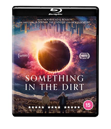 Something In The Dirt" Blu-ray cover with a solar eclipse and two figures.