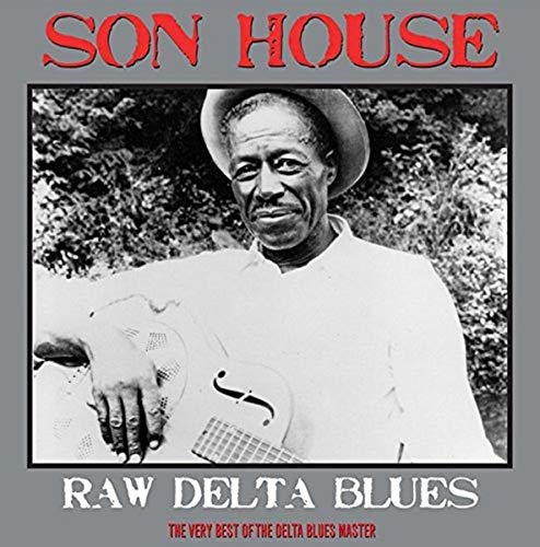 Black and white portrait of Son House wearing a hat and holding a guitar.