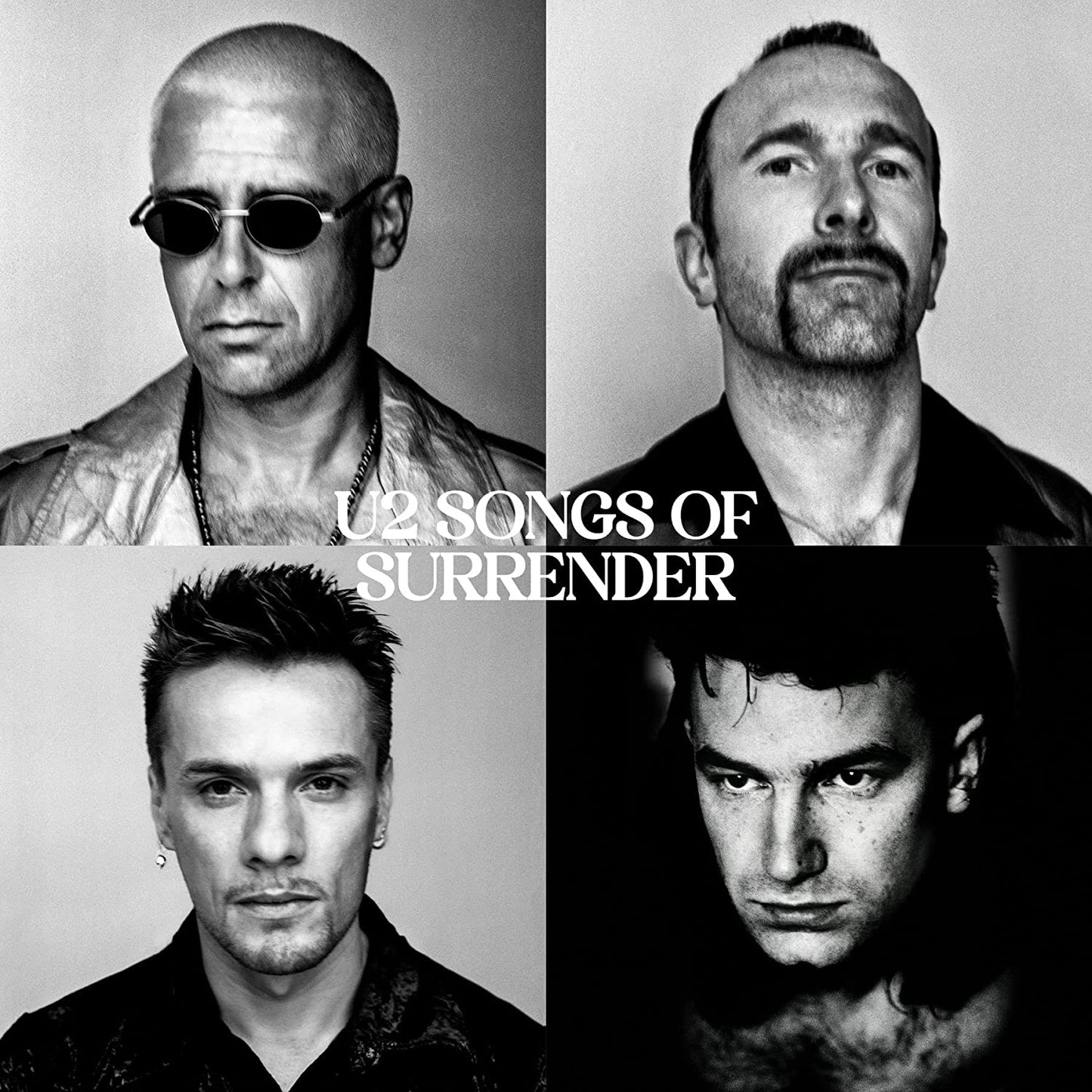 "Black and white album cover featuring four close-up portraits of U2 band members."