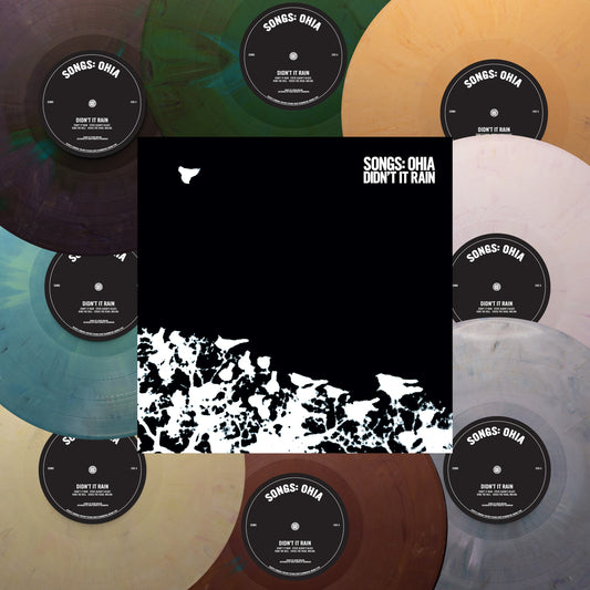 Six vinyl records with patterned labels arranged in a circular display.