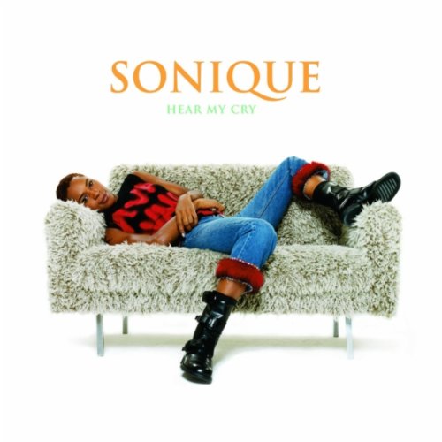 CD cover: Sonique reclining on a shaggy sofa, wearing jeans and boots.