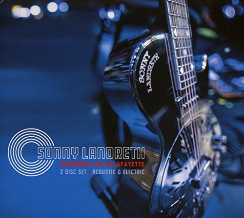 Close-up of a resonator guitar body against a dark blue concert stage background.