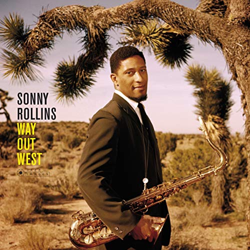 Album cover of Sonny Rollins, holding a saxophone, standing in a desert landscape.