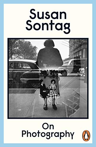 Book cover for "On Photography" by Susan Sontag, featuring a black and white street scene.