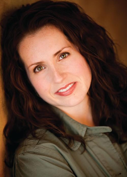 Close-up portrait of a woman with long brown hair and green eyes.