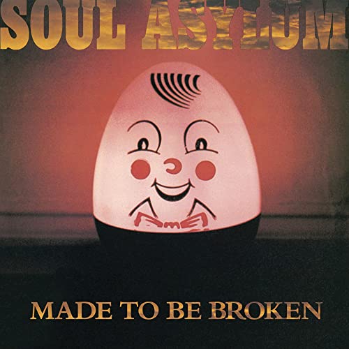 Album cover featuring a glowing Humpty Dumpty toy against a dark, sunset-colored background.