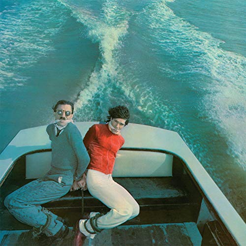 Two men on a speeding boat, viewed from above, in red and white.