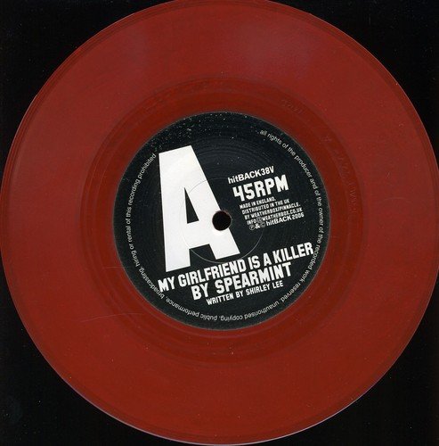 Red seven-inch vinyl record with a black center label featuring white text and logo.