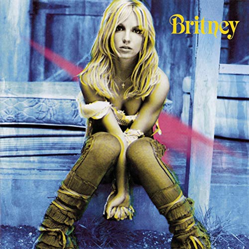 Britney Spears album cover, blonde hair, seated on weathered wood steps.