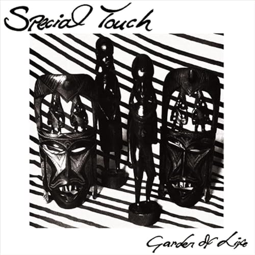 Black and white album cover featuring African masks and figurines.