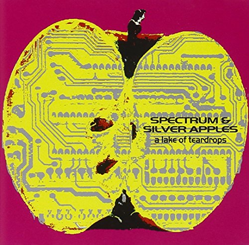 Yellow apple with circuit board design and black silhouetted figures.