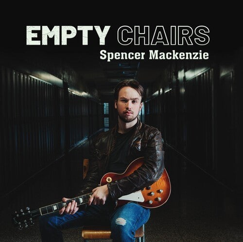 Spencer Mackenzie with guitar, seated in a hallway, album cover.