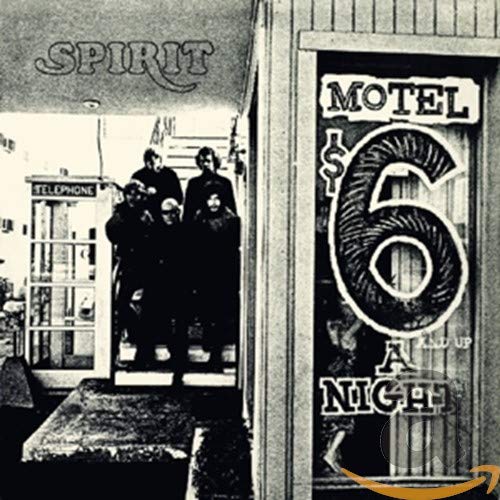 Black and white photo of the band Spirit standing outside a Motel 6.