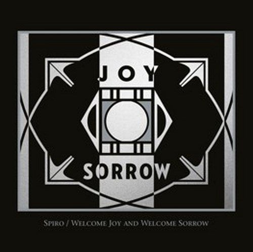 "Dark grey album cover with silver geometric design and 'JOY SORROW' text."