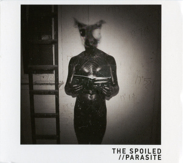 Black and white album cover featuring a figure with an animal mask.