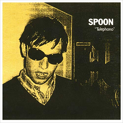 Yellow album cover for Spoon’s “Telephono” featuring a portrait in sunglasses.