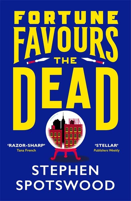 Book cover: yellow title text, cityscape in a crystal ball.